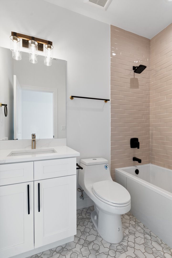 4920 North Whipple Street, Unit 2 Chicago, IL 60625 - Photo 13 of 16 a bathroom with a sink a toilet and shower