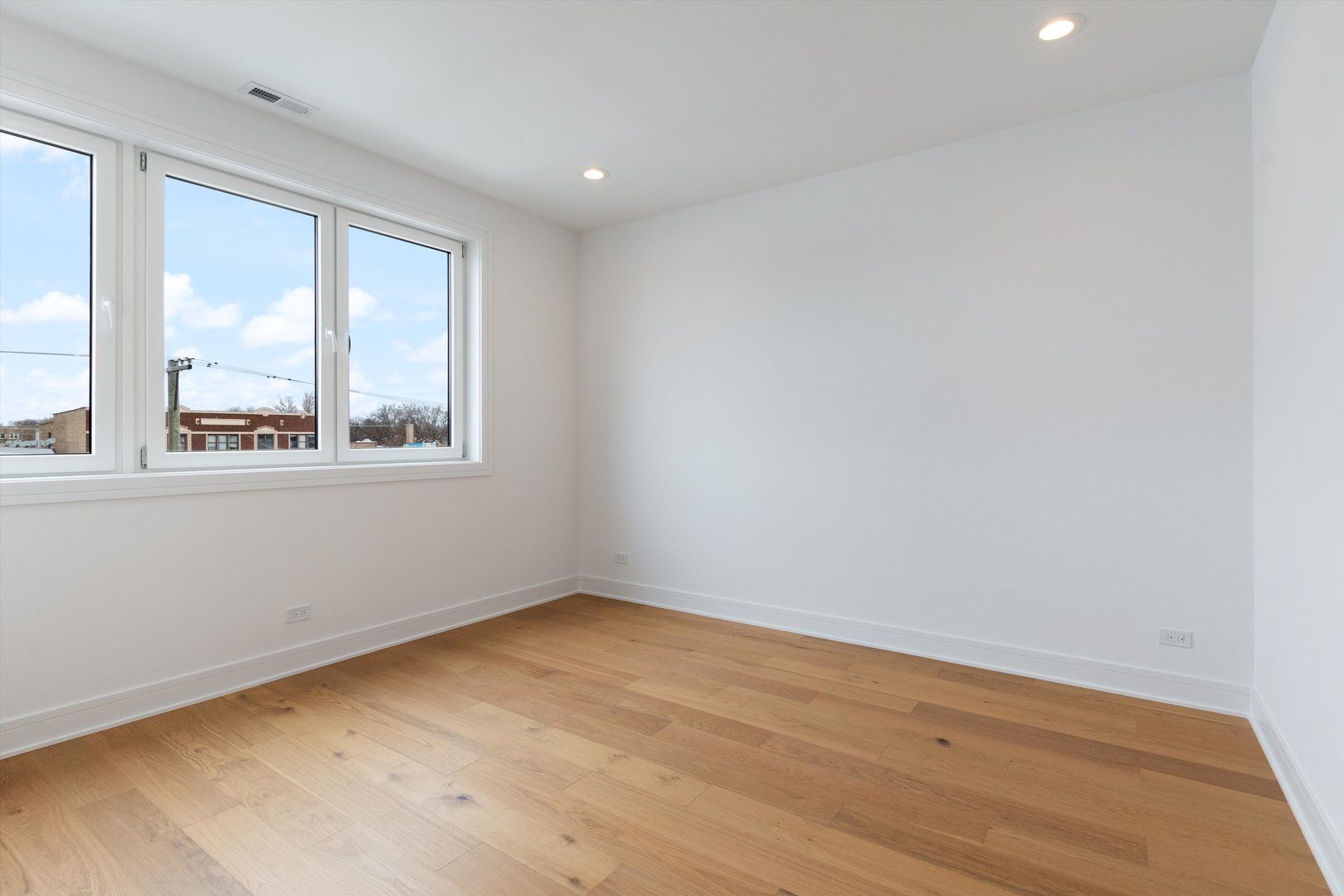 4920 North Whipple Street, Unit 2 Chicago, IL 60625 - Photo 7 of 16 an empty room with a window