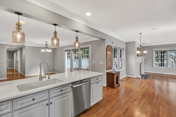 a kitchen with counter top space and wooden floor