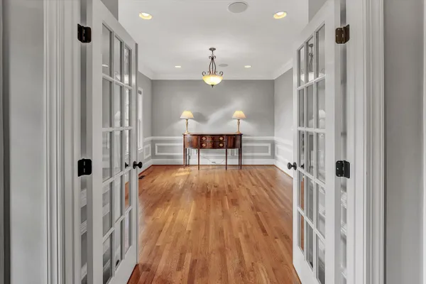 a very nice looking room with wooden floor and a ceiling fan
