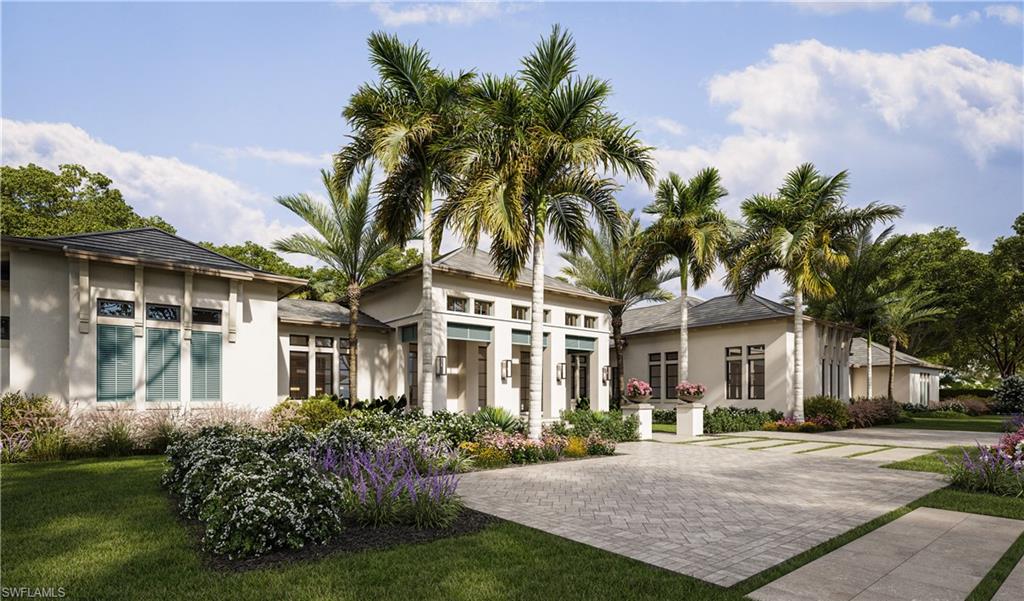 6951 Verde Way Naples, FL 34108 - Photo 2 of 6 a front view of a house with a garden