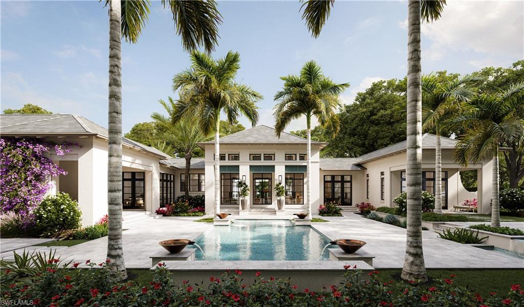 6951 Verde Way Naples, FL 34108 - Photo 4 of 6 a view of a white house with a swimming pool and lawn chairs under an umbrella with palm trees