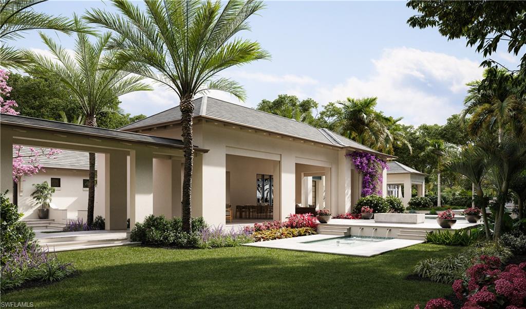 6951 Verde Way Naples, FL 34108 - Photo 5 of 6 a front view of a house with a yard table and chairs
