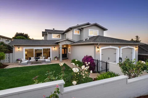 a front view of house with yard and outdoor seating