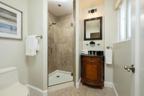 a bathroom with a sink a toilet and shower
