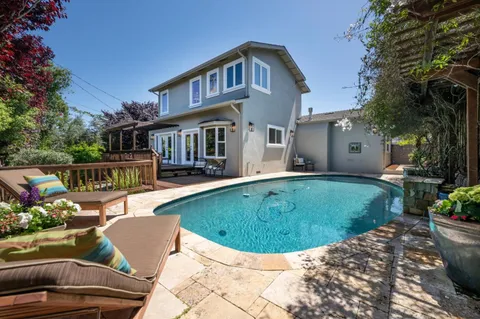 a view of a house with swimming pool and porch