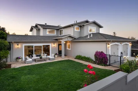 a front view of house with yard and outdoor seating