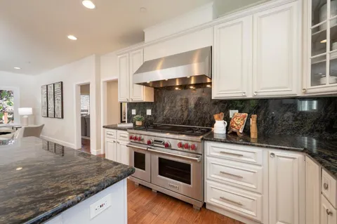a kitchen with stainless steel appliances granite countertop a stove and a sink