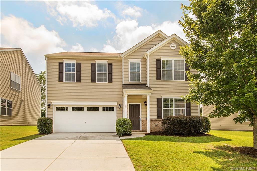 11824 Bending Branch Road Charlotte, NC 28227 - Photo 1 of 23 a front view of a house with yard and green space