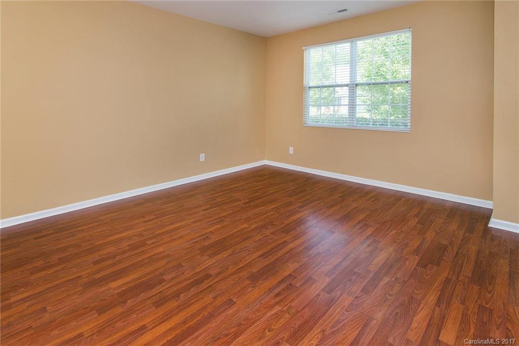 11824 Bending Branch Road Charlotte, NC 28227 - Photo 12 of 23 an empty room with wooden floor and windows