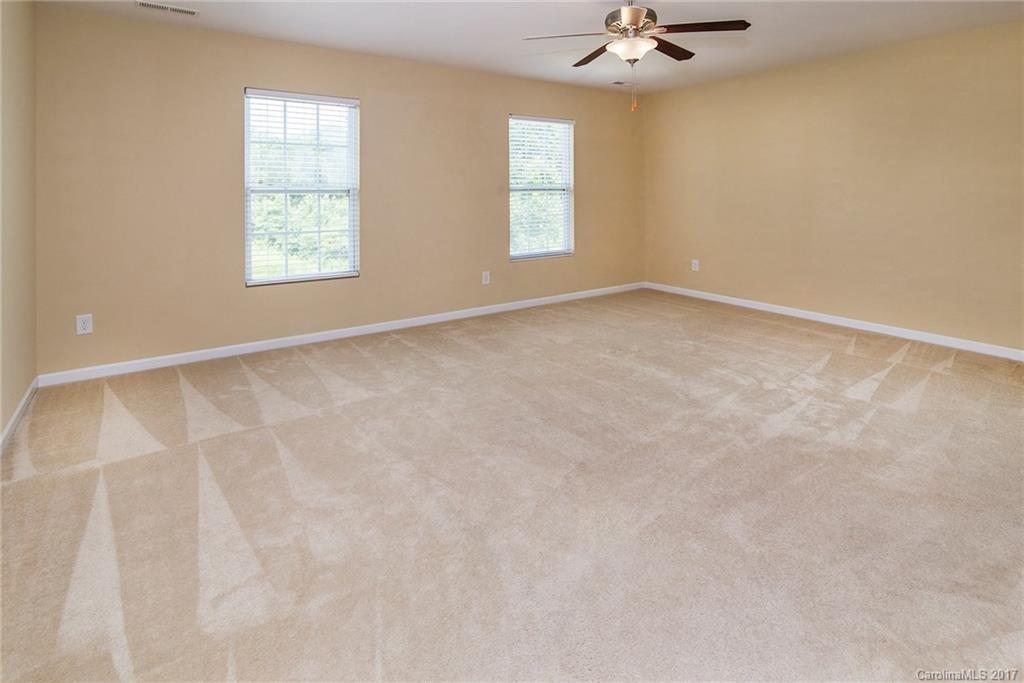11824 Bending Branch Road Charlotte, NC 28227 - Photo 14 of 23 an empty room with a windows and ceiling fan