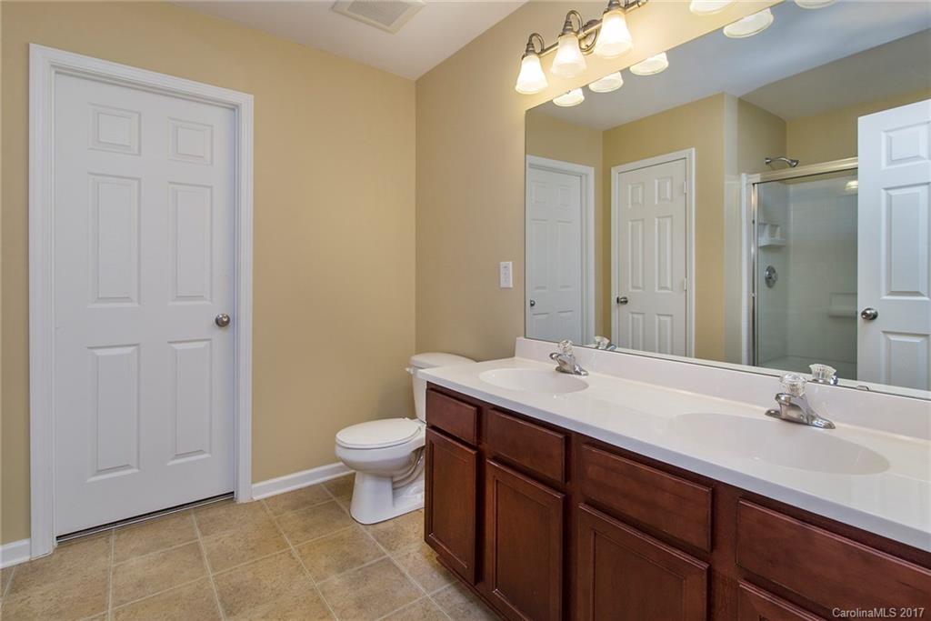 11824 Bending Branch Road Charlotte, NC 28227 - Photo 15 of 23 a bathroom with a sink a toilet and a mirror