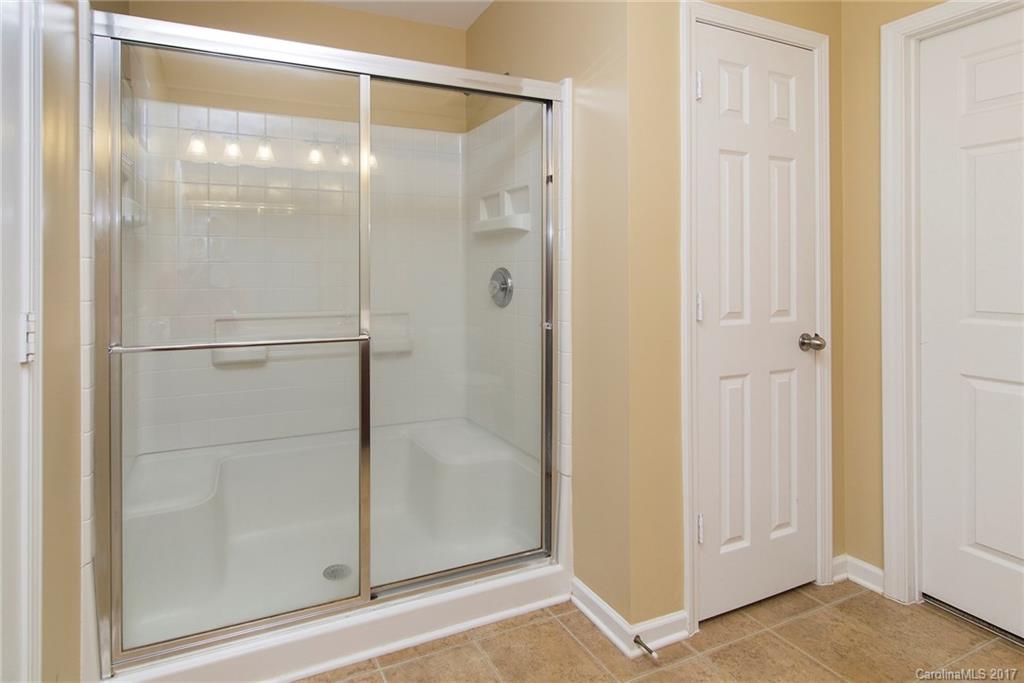 11824 Bending Branch Road Charlotte, NC 28227 - Photo 16 of 23 a bathroom with a glass shower door