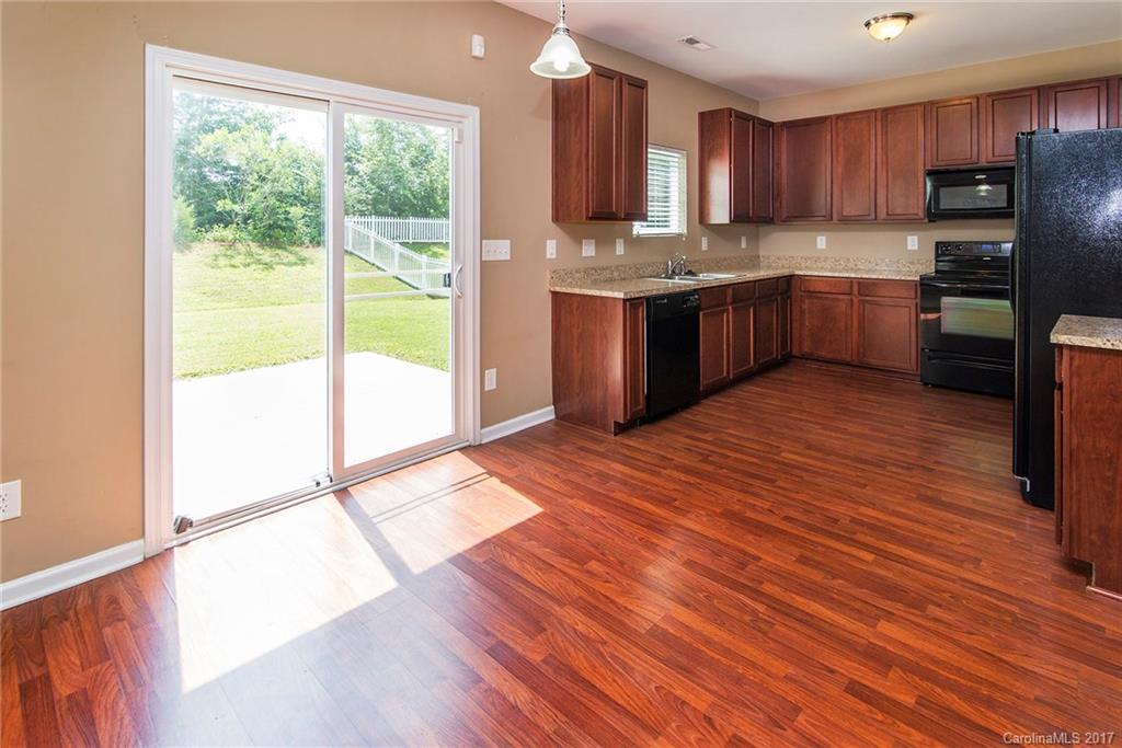 11824 Bending Branch Road Charlotte, NC 28227 - Photo 5 of 23 a kitchen with stainless steel appliances granite countertop a stove a sink and a refrigerator