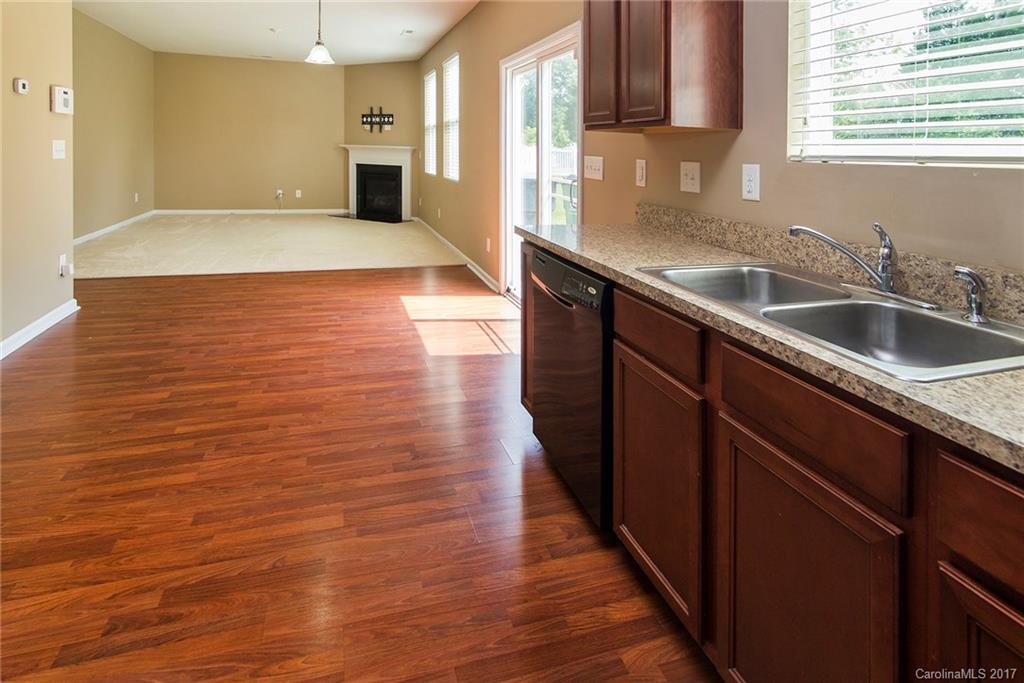 11824 Bending Branch Road Charlotte, NC 28227 - Photo 8 of 23 a kitchen with stainless steel appliances a sink cabinets and wooden floor