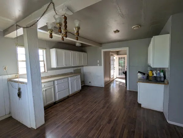 a kitchen with cabinets a sink and appliances