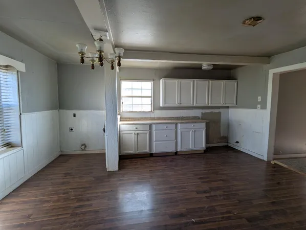 a view of a kitchen with wooden floor and a sink