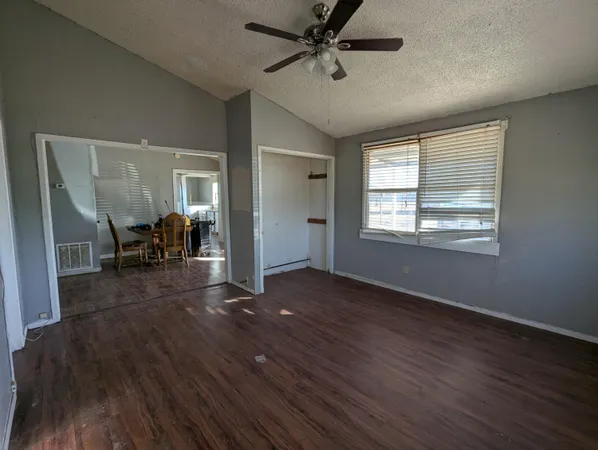 a view of livingroom with hardwood floor and a ceiling fan
