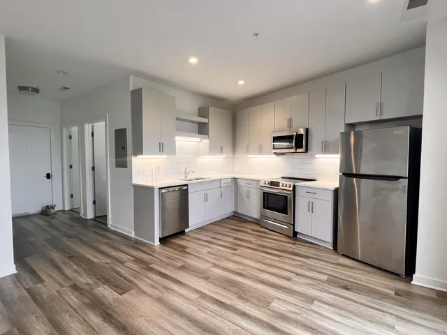 a kitchen with stainless steel appliances a refrigerator sink and cabinets