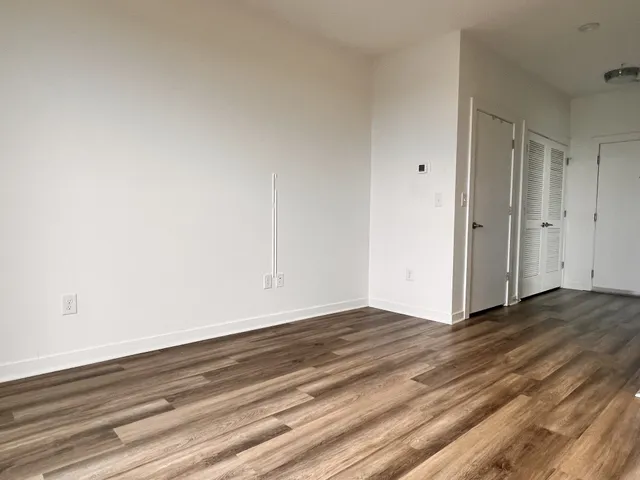 a view of an empty room and wooden floor