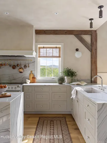 a view of hall way with furniture and chandelier