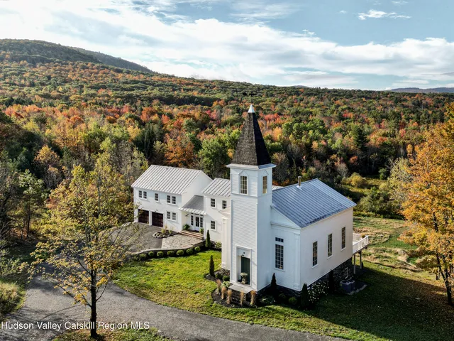 a living room with fireplace furniture and a large window