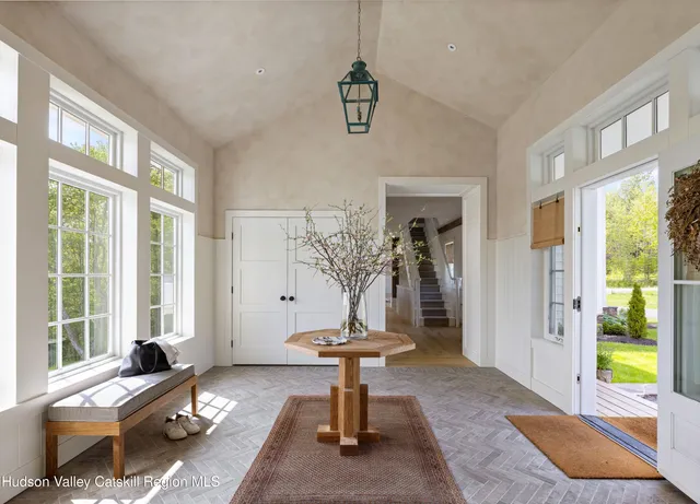 a living room with furniture and large windows