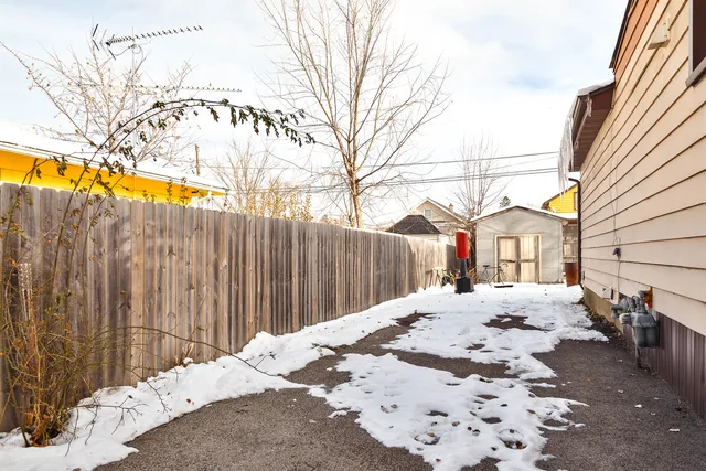 a front view of a house with a snow on the road