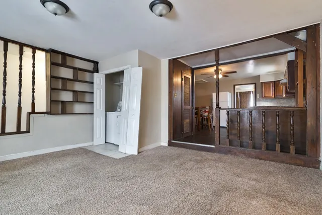 an empty room with windows and closet