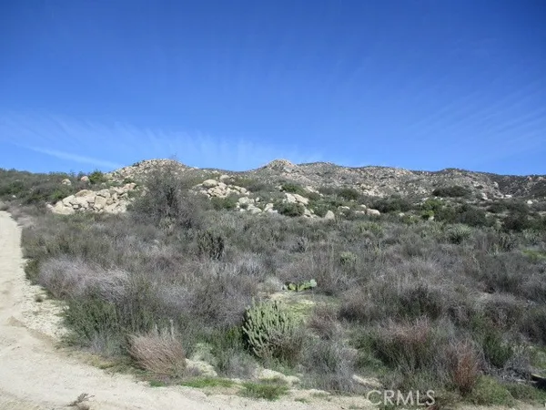 a view of a mountain in the distance in a field