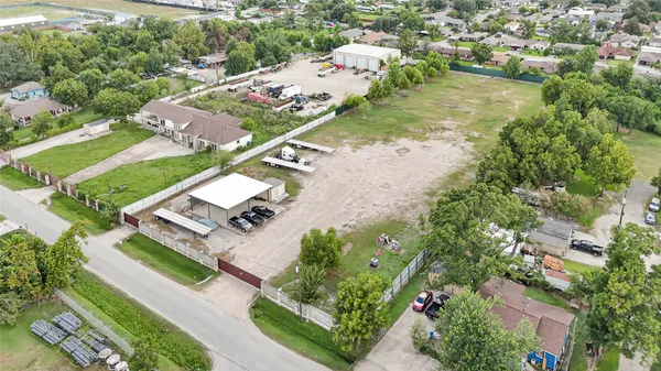 an aerial view of a house with a yard basket ball court and outdoor seating
