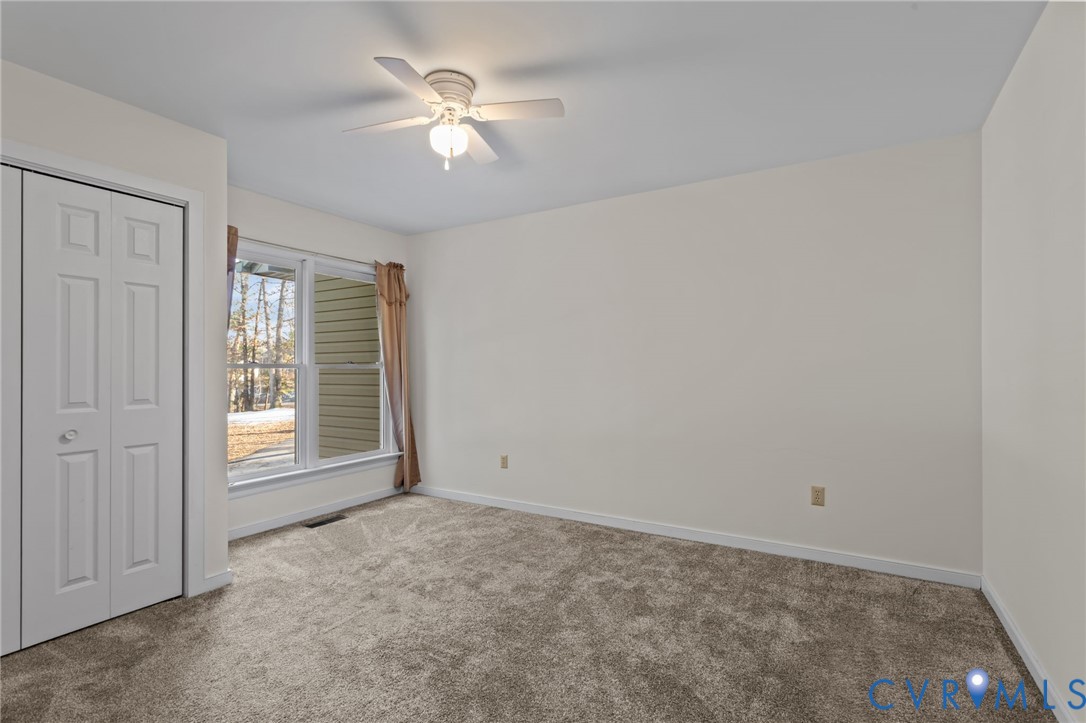 518 Rebel Ridge Road Colonial Heights, VA 23834 - Photo 19 of 44 an empty room with windows and fan