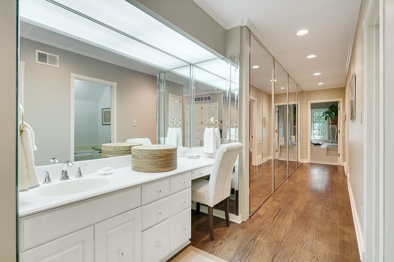 388 South Shady Grove Road Memphis, TN 38120 - Photo 13 of 25 Master Bathroom. A view looking down the hall of the Master Bathroom which shows the abundance of closets (left) and entry into the spa room (background). The separate, full baths contain tile flooring.