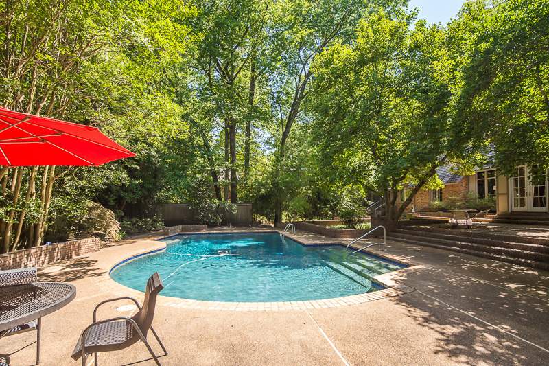 388 South Shady Grove Road Memphis, TN 38120 - Photo 24 of 25 Positioned on ~1 acre with this gorgeous pool! Behind is the pool house, which is so charming! It contains a vaulted sitting room with kitchenette and bar as well as a 1/2 bath! Beyond the bamboo (background), you will find some enchanting play spaces!