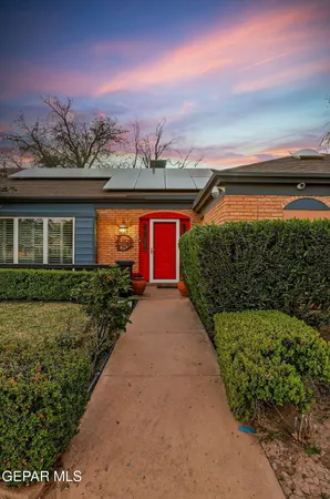 a kitchen with stainless steel appliances granite countertop a stove top oven a dining table and chairs with the wooden floor
