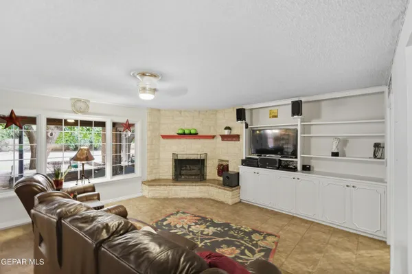 a spacious bedroom with a bed a couch and large window