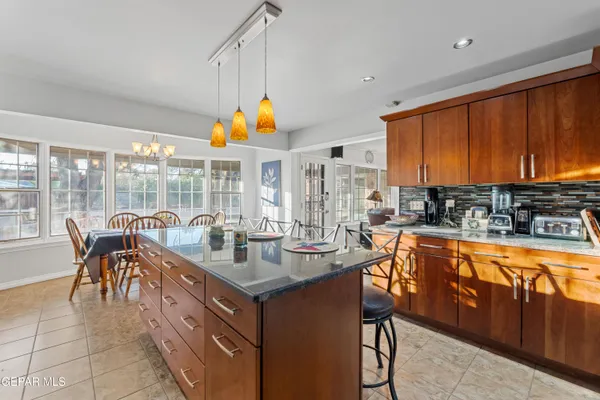 a dining room with furniture a chandelier and window