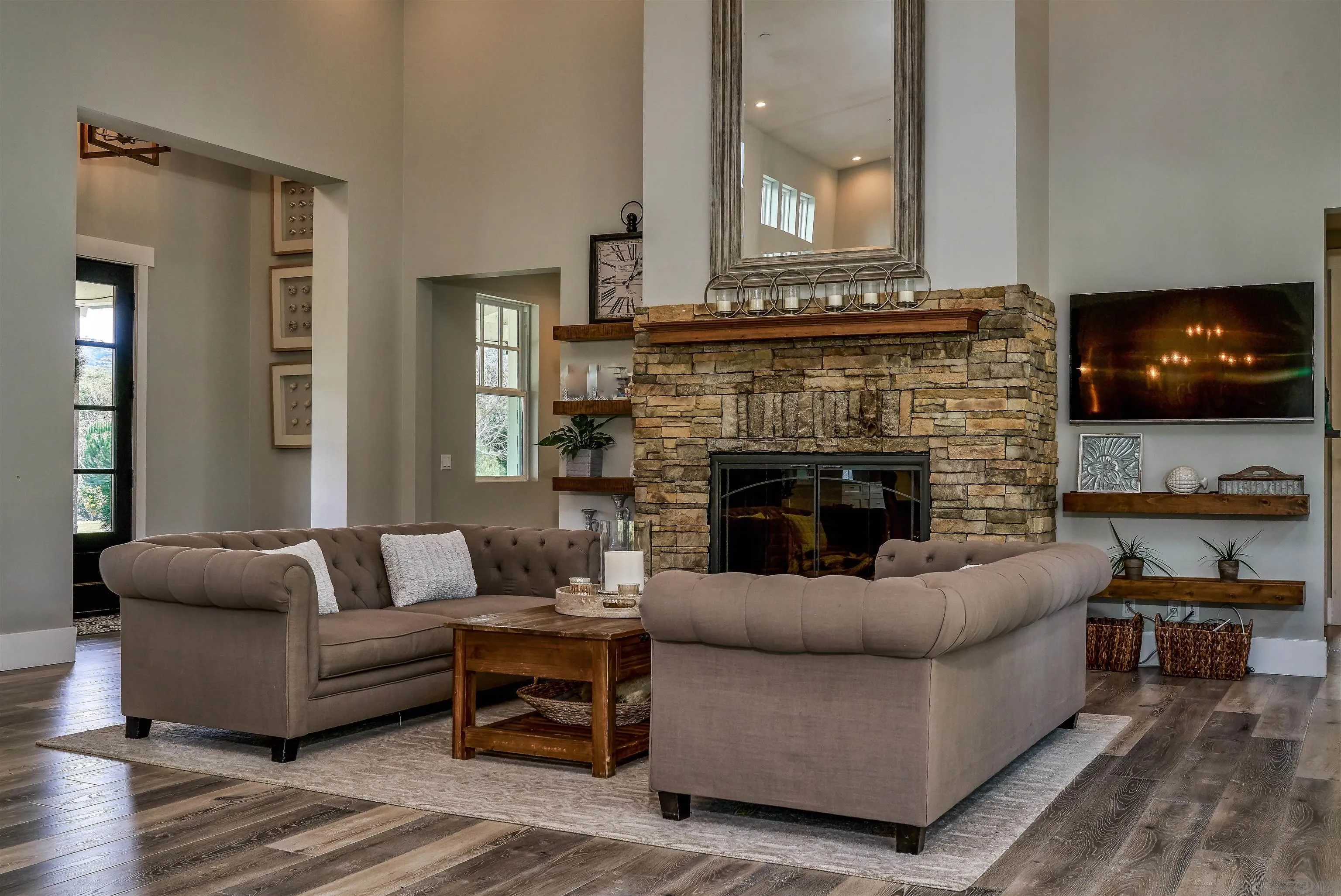 20104 Questhaven Road Elfin Forest, CA 92029 - Photo 13 of 33 a living room with furniture a flat screen tv and a fireplace