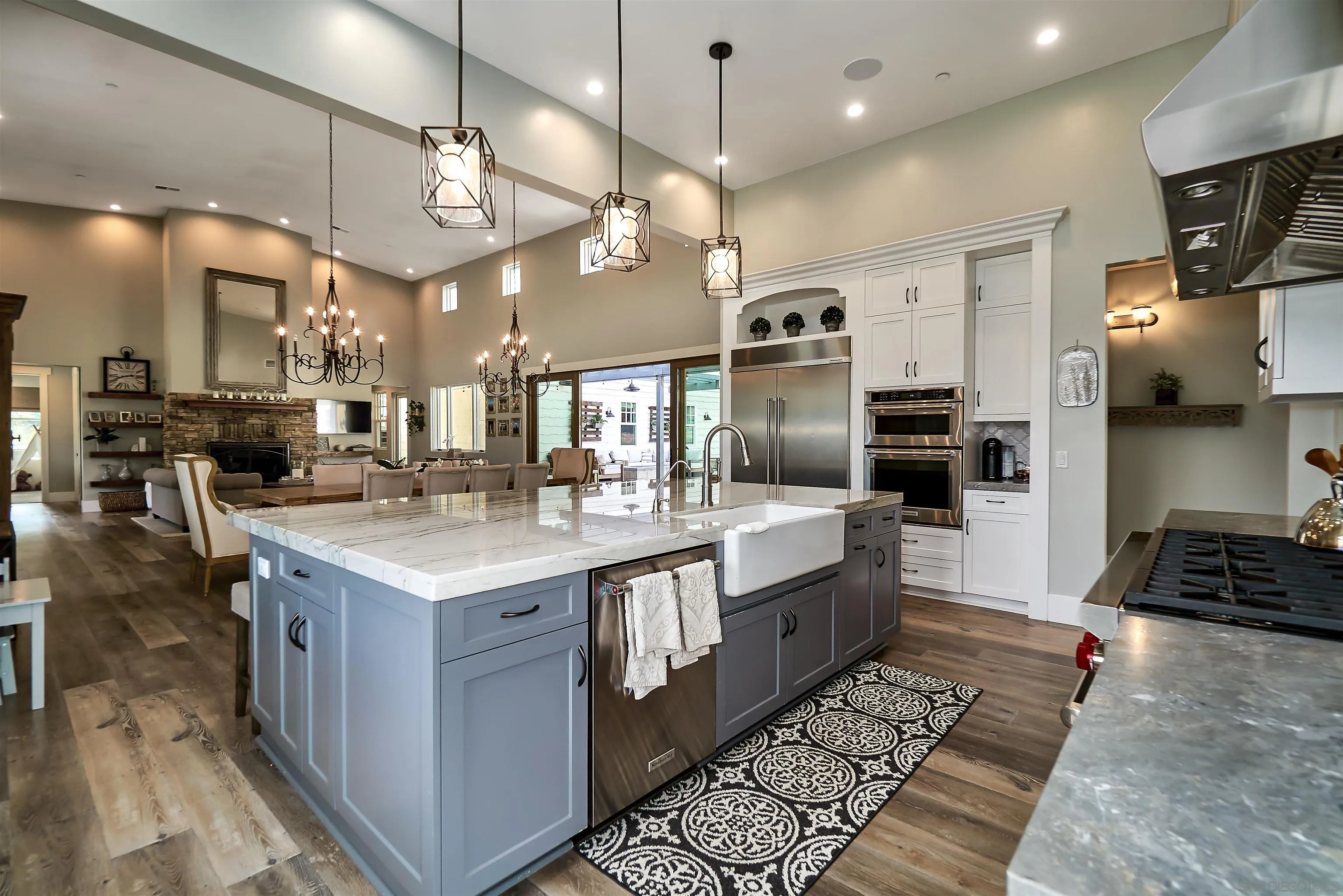 20104 Questhaven Road Elfin Forest, CA 92029 - Photo 15 of 33 a large kitchen with stainless steel appliances a large counter top a stove and a sink