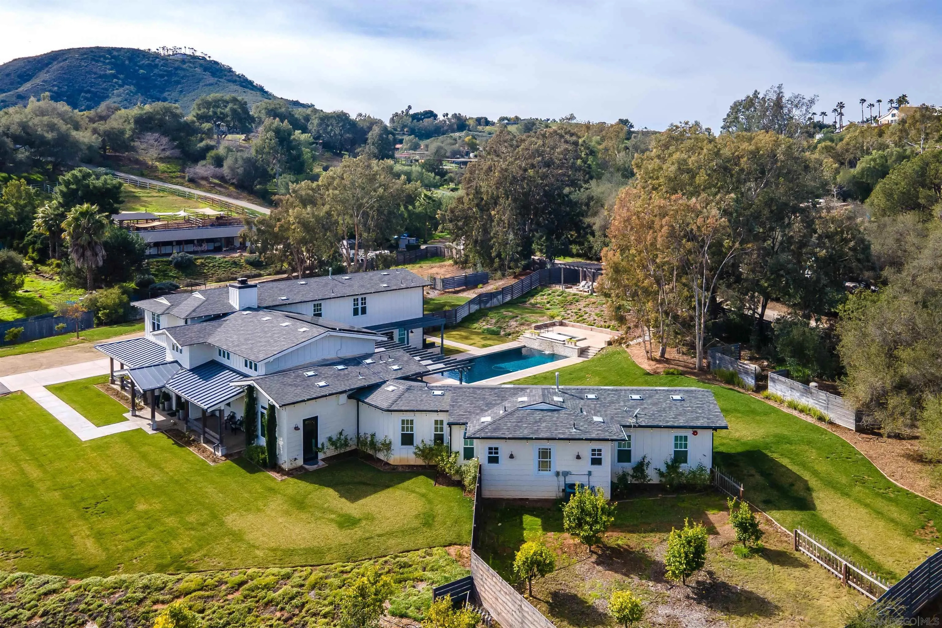 20104 Questhaven Road Elfin Forest, CA 92029 - Photo 3 of 33 a aerial view of a house with swimming pool and mountains