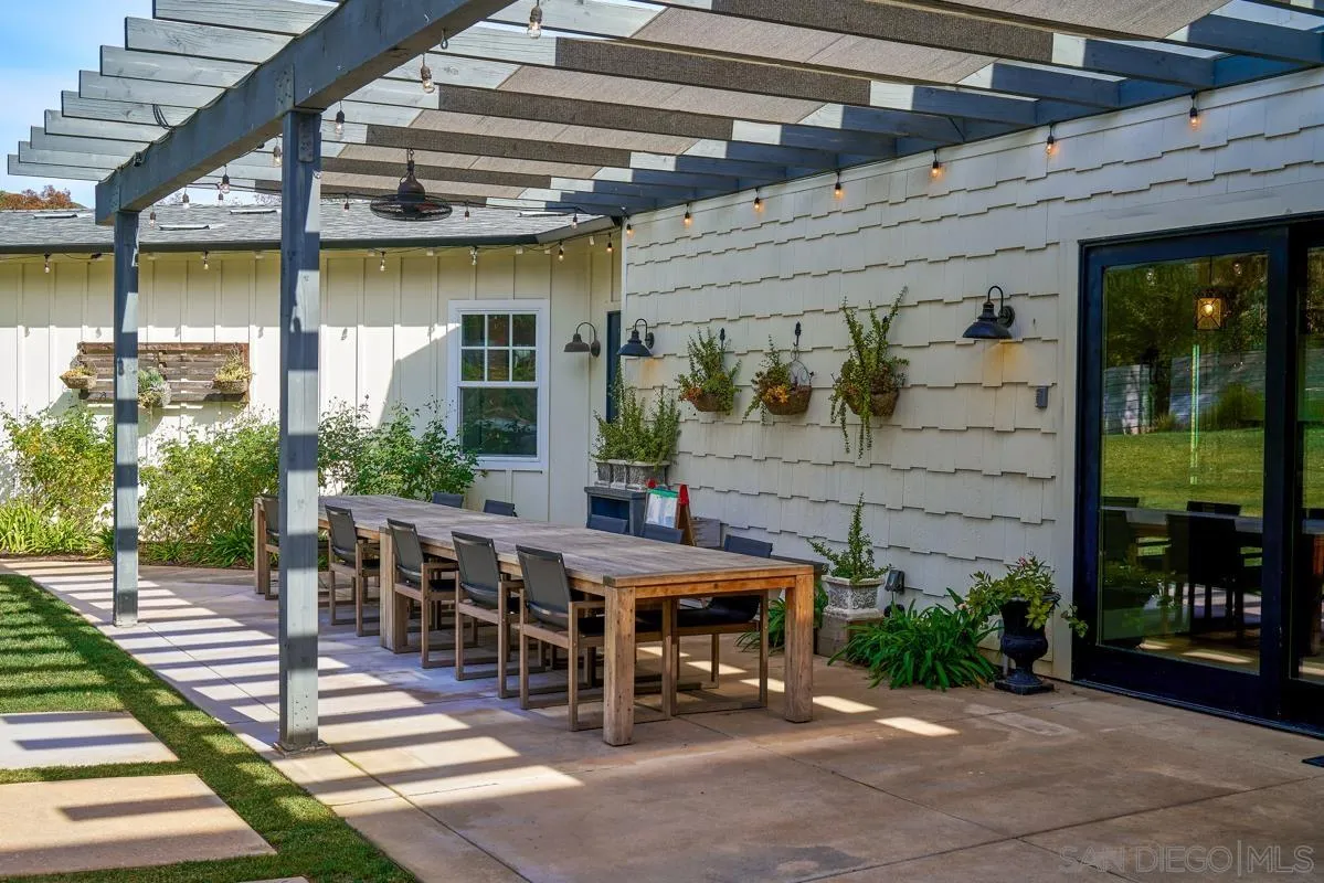20104 Questhaven Road Elfin Forest, CA 92029 - Photo 9 of 33 a view of a patio with table and chairs with wooden floor and plants