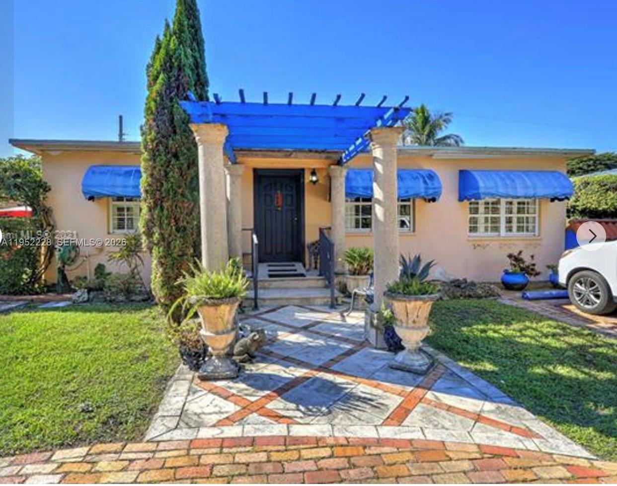 3030 Southwest 57th Avenue Miami, FL 33155 - Photo 1 of 12 a front view of a house with garden