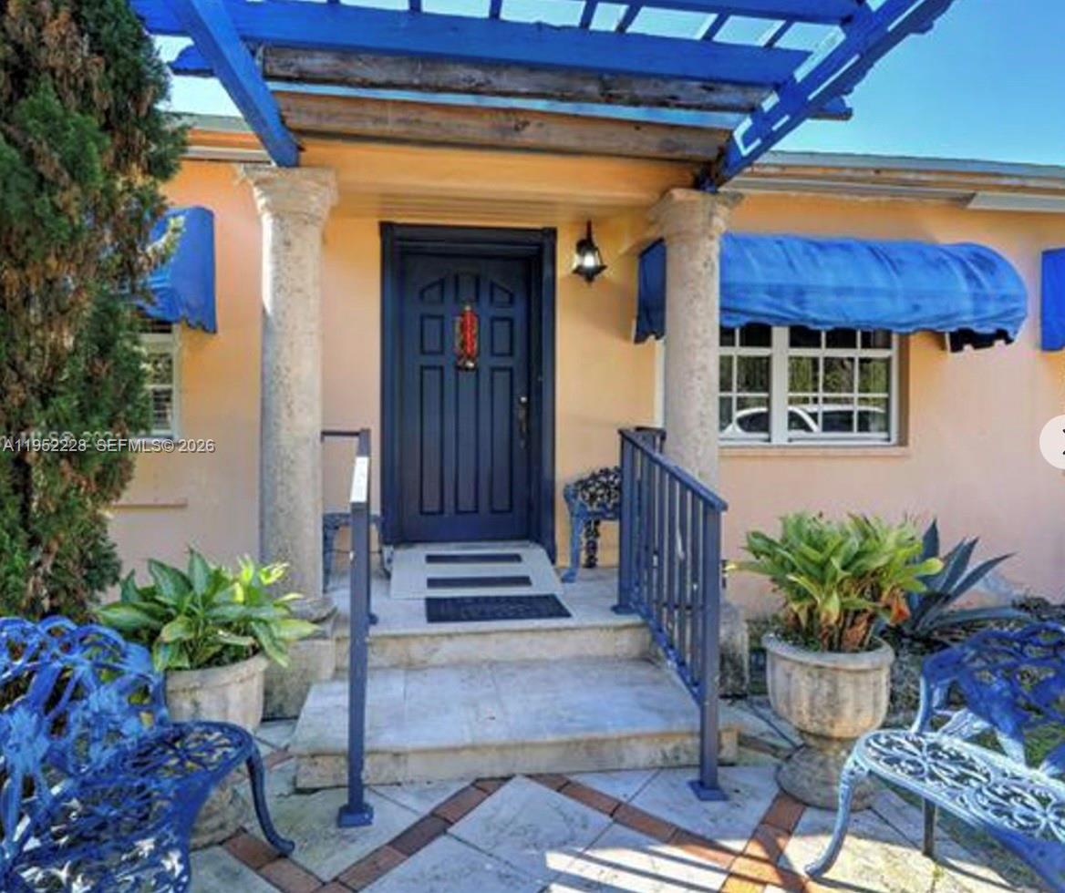 3030 Southwest 57th Avenue Miami, FL 33155 - Photo 2 of 12 a potted plant sitting in front of a house