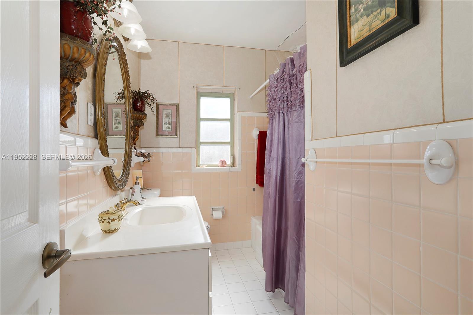 3030 Southwest 57th Avenue Miami, FL 33155 - Photo 5 of 12 a bathroom with a sink vanity and mirror
