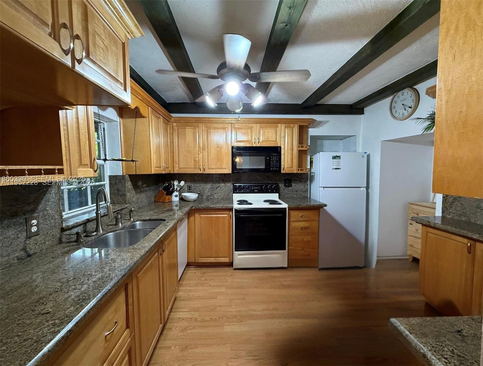 3030 Southwest 57th Avenue Miami, FL 33155 - Photo 9 of 12 a large kitchen with stainless steel appliances granite countertop a sink window and refrigerator