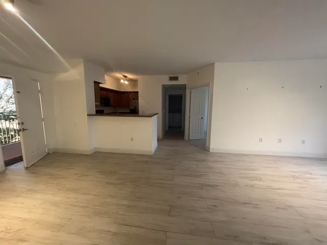a view of a livingroom with wooden floor and a sink