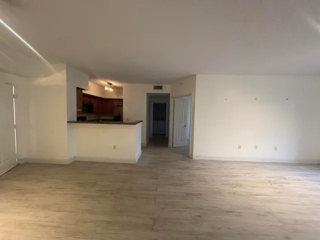a view of a livingroom with an empty space and a fireplace