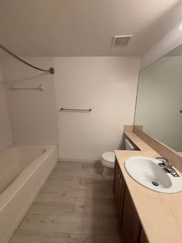 a bathroom with a sink a toilet and bathtub