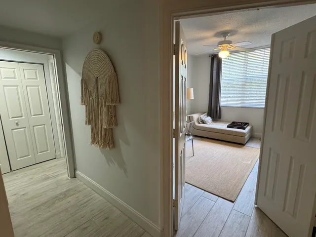 a view of walk in closet with wooden floor