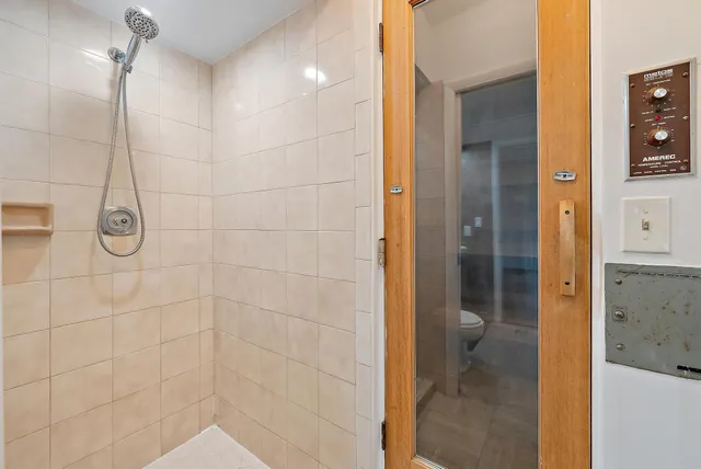 a bathroom with a shower and a sink